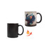 A colour changing mug in black and a vibrant design revealing text and splashes of colour when heated.