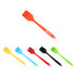 A set of pastry brushes in orange, yellow, blue, black, and green, featuring a logo on one brush.