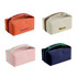 A portable canvas cosmetic bag in orange, cream, pink, and navy, featuring zippers and handles. Some have branding.