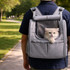 A grey pet backpack carrier with an expandable design, featuring a mesh window and a cat peeking out.