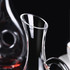 A handled wine decanter made of clear glass, featuring a sleek design and a distinctive pouring spout.