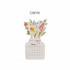 A floral desk calendar featuring a bouquet of flowers in pastel colours, with a white base and pink ribbon.