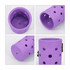 A drink holder in purple, featuring multiple holes and a textured base, with a small logo on the side.