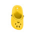 A yellow paw-shaped clog shoe fridge magnet with ventilation holes and a black button detail.
