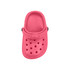 A bright pink clog shoe fridge magnet featuring ventilation holes and a raised band. Includes a logo or branding.