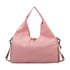 A pink duffle bag featuring a yoga mat strap and a shoulder sling. It has a simple, modern design.