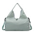 A light green duffle bag with a yoga mat strap, featuring a logo and adjustable shoulder strap.