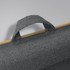 A grey fabric handle attached to a bamboo lap desk, highlighting the texture and natural material.