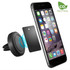 A round black car phone holder next to a smartphone with a magnetic plate for attachment.