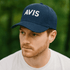A navy blue baseball cap with a structured design and a logo on the front.