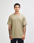 A heavyweight unisex T-shirt in a muted olive green colour, displayed on a model with curly hair.