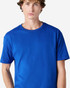 A blue heavyweight cotton unisex T-shirt laid flat, featuring a rounded neckline and short sleeves. It has a logo.