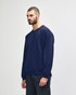A navy Gildan Heavy Blend adult crewneck sweatshirt displayed on a model wearing blue jeans.