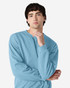A blue Gildan Heavy Blend adult crewneck sweatshirt worn by a model, featuring a casual pose and long sleeves.