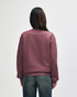 A maroon Gildan Heavy Blend adult crewneck sweatshirt, viewed from the back, featuring long sleeves and a simple design.