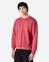 A red Gildan Heavy Blend adult crewneck sweatshirt displayed on a model, featuring long sleeves and a relaxed fit.