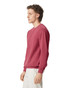 A maroon adult crewneck sweatshirt displayed on a model from the side, featuring long sleeves and a fitted design.