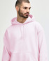 A model wearing a pink Gildan Heavy Blend Adult Hooded Sweatshirt with the hood up.