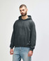 A grey hooded sweatshirt with a front pocket and drawstring details, worn by a model standing casually.