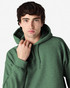 A green hooded sweatshirt with a large hood, featuring a logo, worn by a male model.