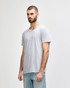A grey Gildan Softstyle adult v-neck t-shirt displayed on a male model, featuring a logo on the shirt.