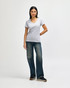 A grey ladies' V-neck T-shirt displayed on a model, paired with dark jeans and casual shoes.