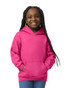 A girl wearing a pink Gildan Heavy Blend youth hooded sweatshirt, featuring a front pocket and hood.