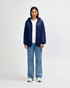 A navy blue Gildan Heavy Blend adult full zip hooded sweatshirt with a hood and a logo on the back.