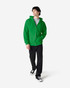A man wearing a green Gildan Heavy Blend full zip hooded sweatshirt, paired with jeans and sneakers.
