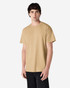 A man wearing a plain khaki Gildan Ultra Cotton adult T-shirt, standing against a white background.