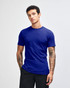 A blue unisex short sleeve t-shirt displayed on a model with curly hair. Features a logo on the shirt.
