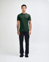 A green unisex fine jersey short sleeve T-shirt paired with blue denim jeans, worn by a model.