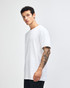 A white unisex fine jersey short sleeve t-shirt displayed on a model from the side. The shirt has a logo.