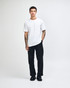 A white unisex short sleeve t-shirt with a fitted design, modelled by a person. Features a branding logo.