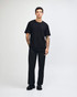 A black unisex fine jersey short sleeve t-shirt displayed on a model, featuring a simple design and relaxed fit.