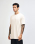 A side view of a beige unisex short sleeve t-shirt worn by a model, featuring a logo on the sleeve.