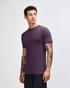 A purple unisex short sleeve t-shirt displayed from the side, featuring a simple design and a brand logo.