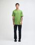 A unisex fine jersey short sleeve T-shirt in vibrant green, worn by a model in casual denim. It features a logo.