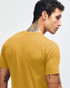 A mustard yellow short sleeve t-shirt featuring a crew neck and a subtle logo on the back.