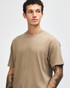 A unisex garment dyed heavyweight cotton t-shirt in a neutral brown colour, featuring a simple design and crew neck.