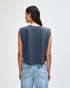 A women's muscle T-shirt in a dark blue shade, featuring short sleeves and a cropped design, with branding on the back.