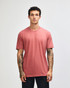 A unisex CVC short sleeve t-shirt in a muted reddish tone, featuring a simple design and a logo.
