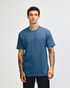 A unisex short sleeve t-shirt in a blue shade, displayed on a model with straight posture. Features a logo.