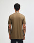 A unisex short sleeve t-shirt in a light brown hue, featuring a simple design and a logo on the back.