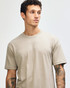 A unisex short sleeve t-shirt in khaki, featuring a relaxed fit and a simple design, with a logo visible.