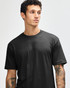A black unisex short sleeve T-shirt worn by a model, showcasing a simple, classic design.