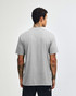 A grey unisex CVC short sleeve T-shirt viewed from the back, featuring a logo.