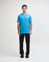 A unisex CVC short sleeve t-shirt in bright blue, worn with black cargo pants, featuring a casual style.