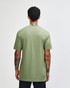 A green unisex CVC short sleeve T-shirt viewed from the back, featuring a plain design and a logo.