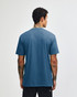 A unisex short sleeve t-shirt in a blue tone with a plain back and a logo on the label.